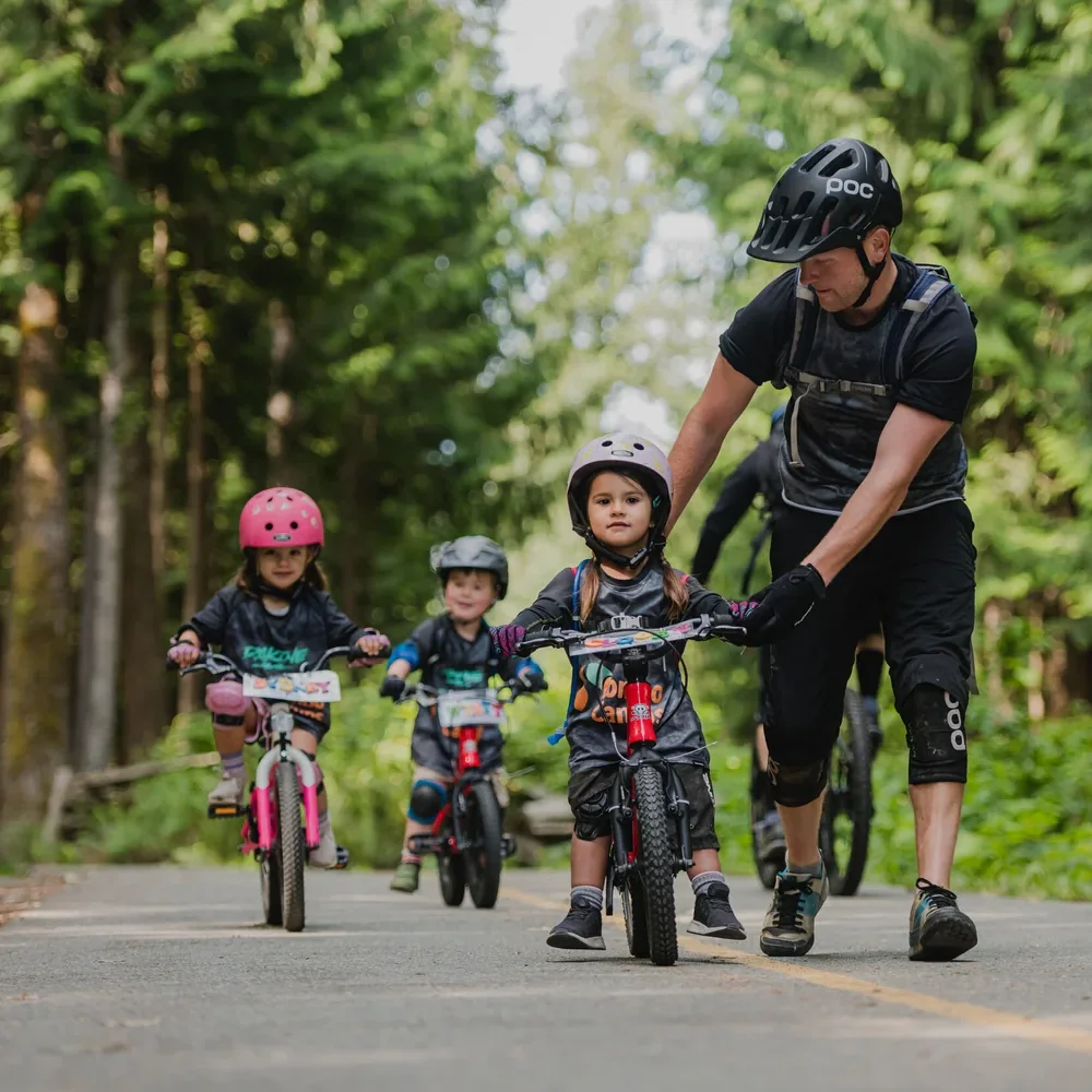Kids and a coach on a forest trail at Combo Camps