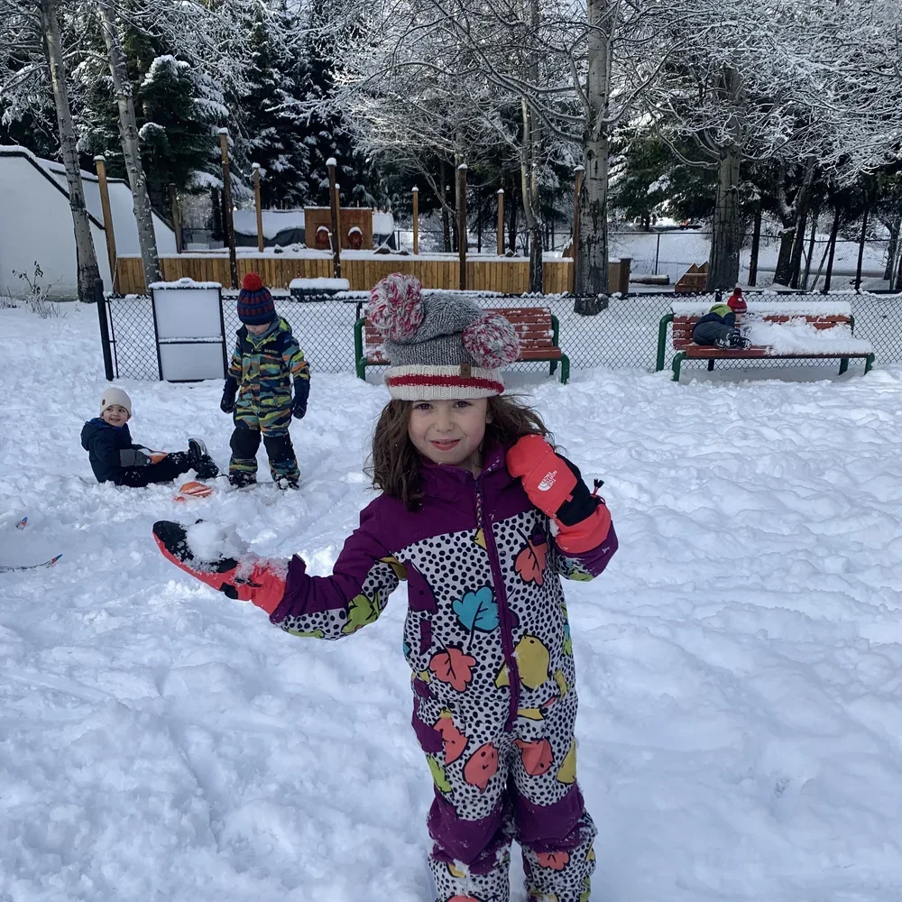 Child playing in the snow at Combo Camps